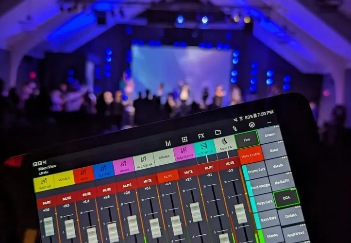 Live event mixing console with venue backdrop